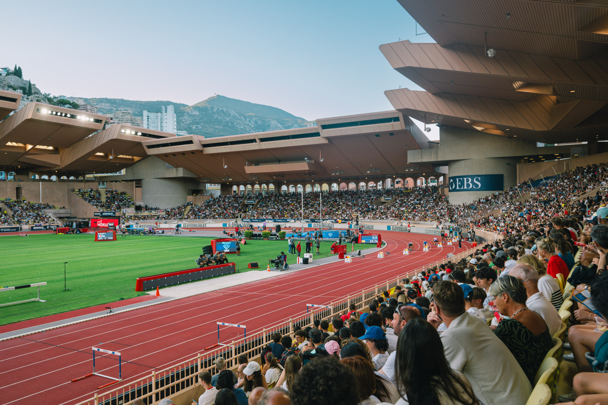 Photographe sportif capturant un athlète en pleine action lors d'un événement sportif